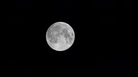 Beaver full moon breaks through clouds over London