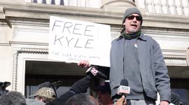 Man holds 'Free Kyle' sign on steps of Kenosha courthouse and says, 'It's not about race'