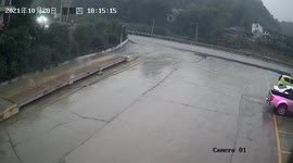 Truck topples over crushing cars after its tire explodes from overloading