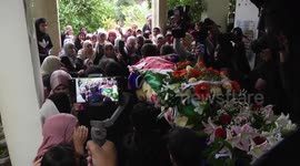 Palestinians carry the body of Isra Ekhzemiya during her funeral at Qabatya village near the West Bank City of Jenin
