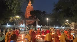 The Buddhist Monks praying out side Mahabodhi temple by candle light for peace around the world