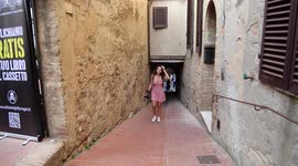 Woman walks through San Gimignano in Italy