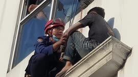 Firefighters rescue desperate man about to jump from third floor in West Jakarta