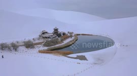 Sand dunes at northern Chinese tourist hotspot blanketed in stunning layer of snow