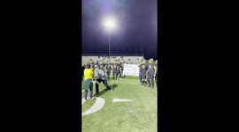California football team cheer as they help their coach with his surprise proposal