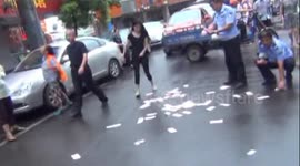 Woman throws cash onto China street in row with husband