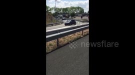Drivers try to reverse out of motorway jam in France