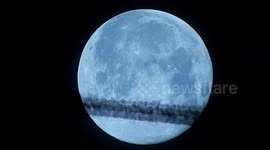 Plane passes blue moon over London