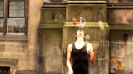 Man juggles while swallowing a sword