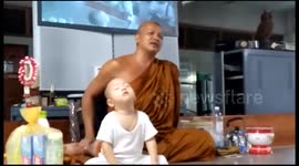 Cute little monk falls asleep while meditating
