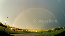 Lightning strikes around rainbow