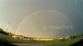 Lightning strikes around rainbow
