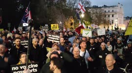 CORRECTS: Protesters gather outside Austrian embassy in London over mandatory vaccine announcement