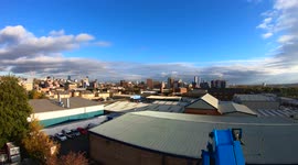 Sunrise to sunset time-lapse overlooking Leeds City centre in northern England