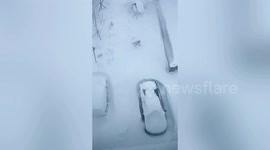 Resident struggles to trudge through snow-covered road in northern China