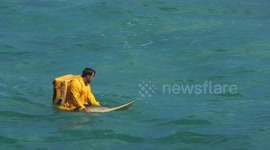 Food delivery man surfing the waves