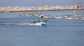 Palestinian fishermen work on the shore of the Mediterranean Sea
