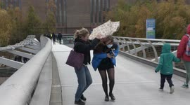 Londoners battle with their umbrellas as Storm Arwen and 50mph winds hit the capital