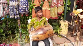 A local seller beats drum to attract visitors during a celebration of the spirit of Tribal Culture, Craft, Cuisine, and Commerce!     An avenue of showcasing the tribal products and helping the artisans connect with the mainstream population has been thet