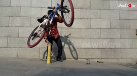 'Balancing a bicycle on a slim, shaky bamboo stick 
'