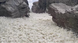 Layer of seafoam whipped up by Storm Arwen covers sea near Cornwall