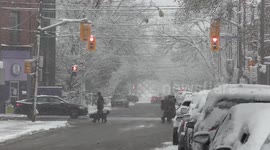 First snowfall of the season in Toronto Canada starts off postcard beautiful and ends with a bang as multiple cars crash and fire trucks and ambulances slide down icy streets responding to multiple crashes on black ice that formed in the evening as temper