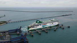 Aerial footage shows giant ferry docking at Holyhead in Wales, then unloading cars and lorries from Ireland