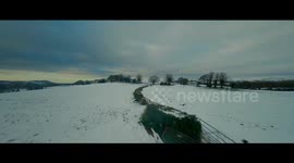 Drone footage reveals UK countryside blanketed in snow in wake of Storm Arwen