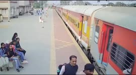 Dramatic moment woman passenger slips from moving train but is saved by the police man