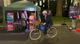 UK PM Boris Johnson visits stalls and rides a bike at Christmas food and drink market in Downing Street