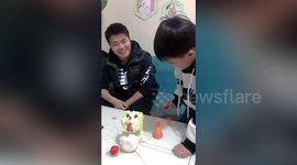 Chinese father skillfully sculpts fruit and veg into animals for his son