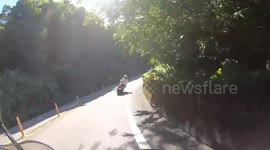 ROAD RAGE: Speeding moped rider overtakes rider on a bend (Dashcam Video)