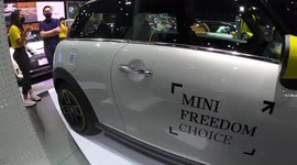 Thailand motor show opens with girls in face masks along with luxury models from Rolls Royce and Aston Martin
