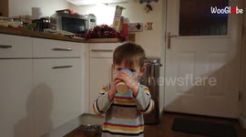 Excited toddler slips and spills milk on himself & the kitchen floor