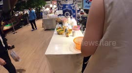 Street food stalls fill ground floor of luxury shopping mall in Thailand