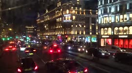 Knightsbridge by night from a double-decker bus - stunning windows of Harvey Nichols store