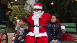 Palestinians enjoy Christmas market and pose with Santa in West Bank's Ramallah