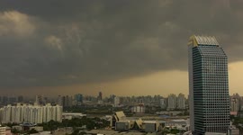 Time-lapse shows rain storm clouds moving over building in Bangkok
