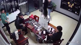 Chaos as cat falls through ceiling at Chinese shop, knocking cups of tea off table