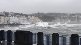 Rough waves whipped up by Storm Barra batter seawall on Isle of Man