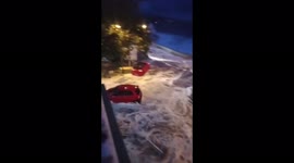 Motorists panic as huge waves crash over seawall and onto their vehicles in Indonesia