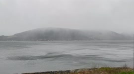 Snow falls and strange waves form as Storm Barra approaches Loch Long in Argyll