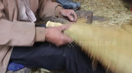 Palestinian man makes traditional straw brooms at his workshop in Roujeeb village, east of the West Bank city of Nablus