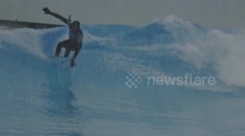 Surfers take to the waves at pool in Swiss Alps despite snowstorm