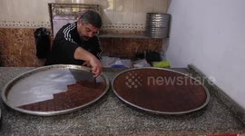 A Palestinian vendor prepares traditional sweet called