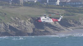 HM Coastguard Helicopter Sikorsky S92 based Newquay Cornwall exercise over Newquay Bay.