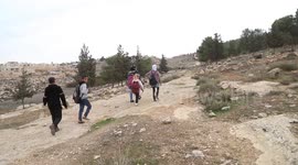 Palestinian students make their way to school at Khirbet Umm Tuba, south of Yatta, in the West Bank city of Hebron