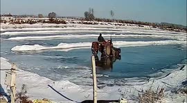 Man driving tractor falls through ice into pond when clearing snow in China