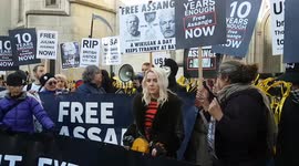 Supporters of Julian Assange hold placards outside Royal Courts of Justice in London