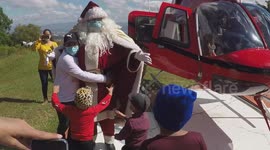 Santa trades in his sleigh for a chopper to bring joy to sick children in Mixco, Guatemala